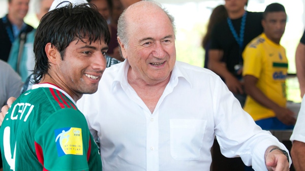 In this photo provided by ACT Productions, FIFA president Sepp Blatter, right, meets Francisco Cati from the Mexican national beach soccer team during the CONCACAF congress in Miami on Monday, May 2, 2011. (AP Photo/ACT Productions, Mitchell Zachs)