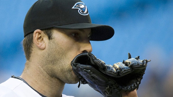 Toronto Blue Jays starting pitcher Brandon Morrow wipes his face with his glove as he walks back to the dugout while playing against the Detroit Tigers during first inning AL baseball action in Toronto on Monday, May 9, 2011. (Nathan Denette/THE CANADIAN PRESS)