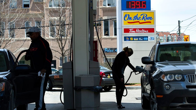 A woman pumps gas in Toronto on Tuesday, May 10, 2011. (Nathan Denette / THE CANADIAN PRESS)