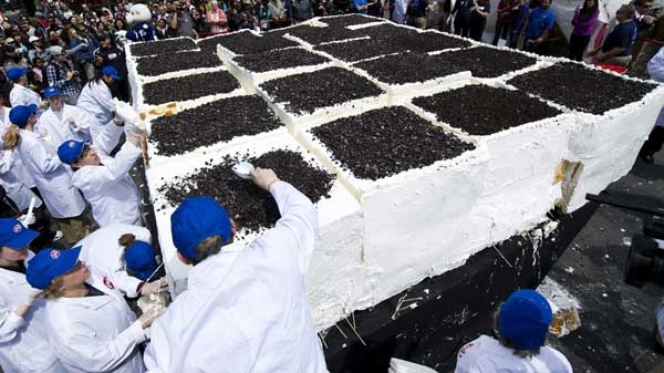 Dairy Queen workers mark the 30th year of making birthday ice cream cakes in Canada by building and setting the Guinness World Record for the world's largest ice cream cake, weighing in at 10,130.35-kilograms, in Toronto on Tuesday, May 10, 2011. (Nathan Denette / THE CANADIAN PRESS)