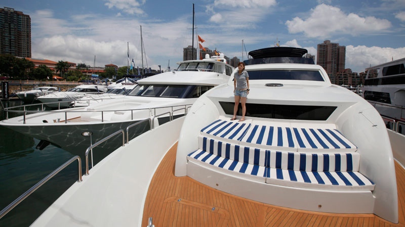 A staff member stands on the Chinese made yacht Accelera 98 at a boat show in Hong Kong, May 6, 2011. (AP / Kin Cheung)