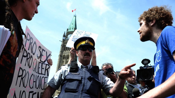 Pro-choice protesters are removed from an anti-abortion rally on Parliament Hill in Ottawa on Thursday, May 12, 2011. THE CANADIAN PRESS/Sean Kilpatrick