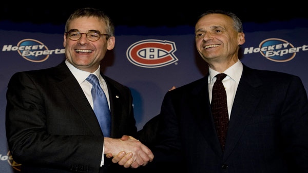Montreal Canadiens' president Pierre Boivin, left, congratulates Pierre Gauthier on his appointment as general manager of the Canadiens at a news conference in Montreal, Monday, Feb. 8, 2010. THE CANADIAN PRESS/Graham Hughes