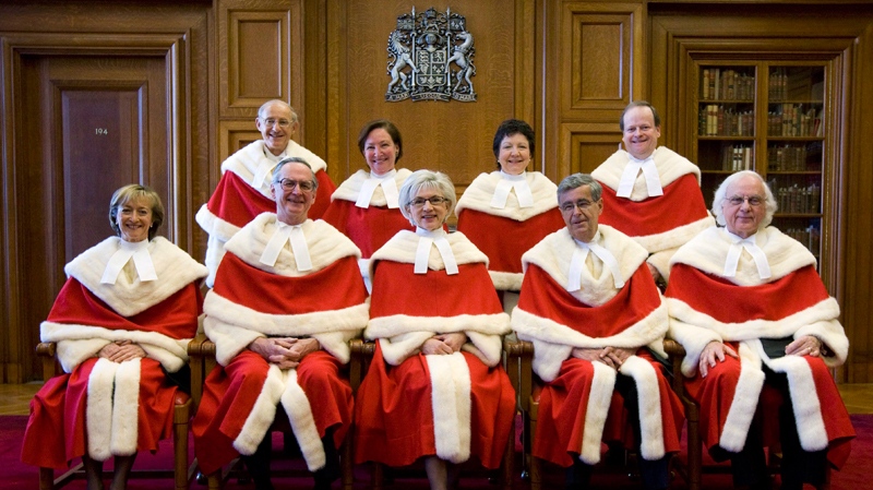 The Supreme Court Justices of Canada pose for a photograph pior to the public swearing of Justice Thomas Cromwell (back right) at the Supreme Court of Canada in Ottawa Monday Feb. 16, 2009. William Binnie is second from the left in the front row. Louise Charron is third from right in back row. (THE CANADIAN PRESS/Adrian Wyld)