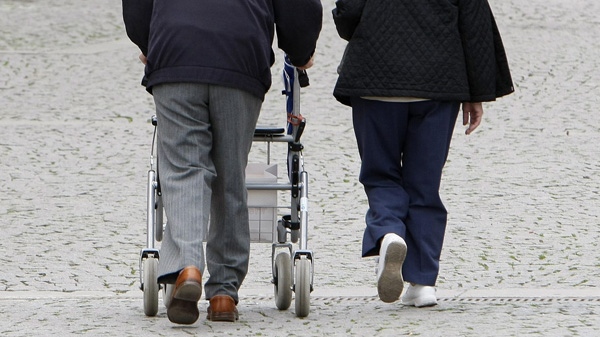 In this May 6, 2009 file photo two elderly persons walk in downtown Stuttgart, Germany. (AP Photo/Thomas Kienzle, File)