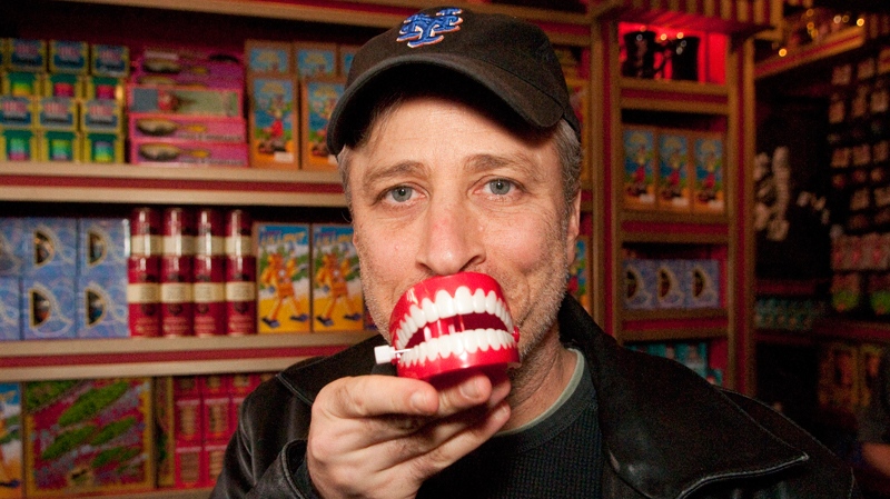 Comedian and TV personality Jon Stewart poses with a chattering teeth novelty toy while visiting Zonko�s joke shop at The Wizarding World of Harry Potter at Universal Orlando Resort on Tuesday, Feb. 8, 2011. (AP Photo/ Universal Orlando Resort, Roberto Gonzalez)