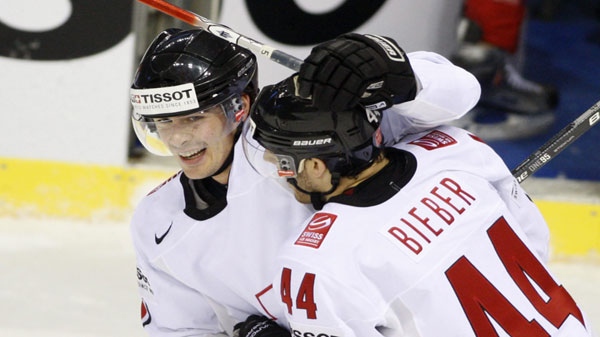 Matthias Bieber, right, from Switzerland congratulates to his teammate Raphael Diaz, left, after scoring against Canada during their preliminary round group B Hockey World Championships match in Kosice, Slovakia, Tuesday, May 3, 2011. (AP Photo/Petr David Josek)