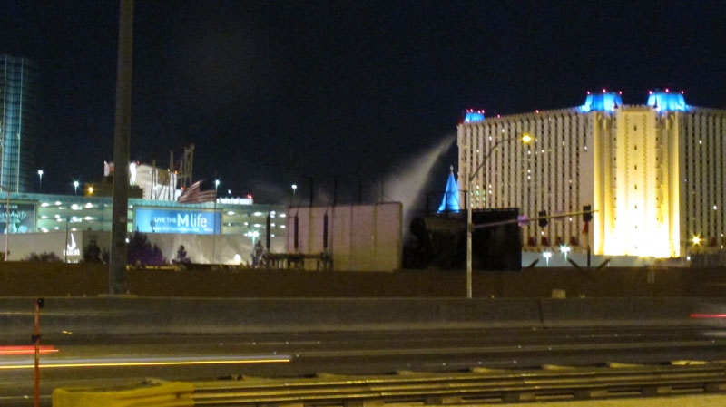 Firefighters douse an electrical transformer station behind several Las Vegas Strip casinos early Sunday, May 15, 2011. A transformer exploded, knocking out power to parts of some hotels and touching off a smoky blaze that snarled traffic. (AP Photo/Oskar Garcia)