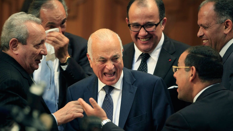 Egyptian Foreign Minister Nabil Elaraby, center, laughs as he is surrounded at the Arab League headquarters in Cairo, Egypt, Sunday, May 15, 2011. After a last minute change of candidates, Elaraby was elected the new secretary-general of the the 22-member organization. (AP Photo/Amr Nabil) 