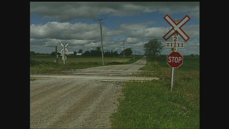 A railway crossing that involves two tracks is seen in southwestern Ontario on Tuesday, August 13, 2013.