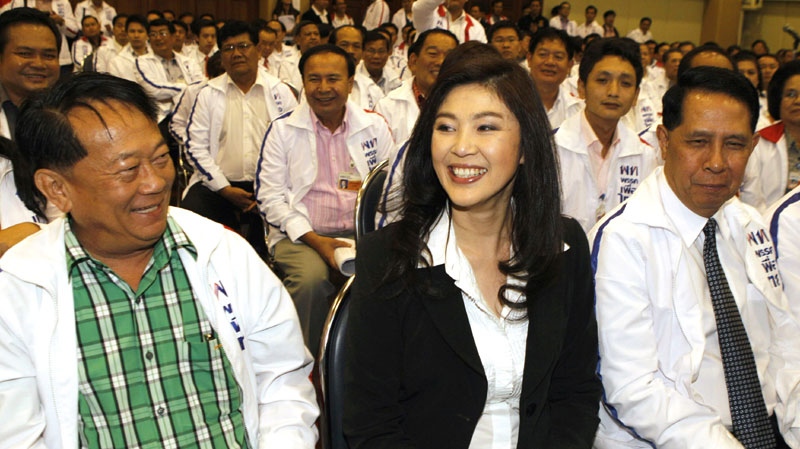 Yingluck Shinawatra, a member of Pheu Thai Party, center, sits with fellow party members at the party headquarters in Bangkok, Thailand, on Monday, May 16, 2011. (AP Photo/Sakchai Lalit)