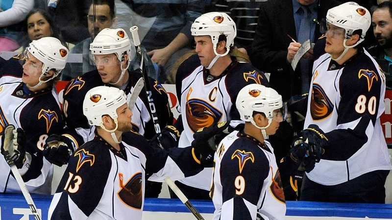 Atlanta Thrashers' Rob Schremp (13) and Evander Kane (9) celebrate Schremp's goal against the New York Islanders with teammates during the second period of an NHL hockey game in Uniondale, N.Y., Thursday, March 24, 2011. (AP-Kathy Kmonicek THE CANADIAN PRESS)