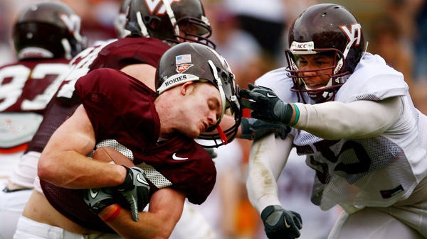 Virginia Tech Maroon team player Daniel Dyer, left, gets his helmet ripped off by White team player Isaiah Hamlette (55) during the spring football game at Lane Stadium, Saturday, April 23, 2011, in Roanoke, Va. (AP Photo/The Roanoke Times, Kyle Green)
