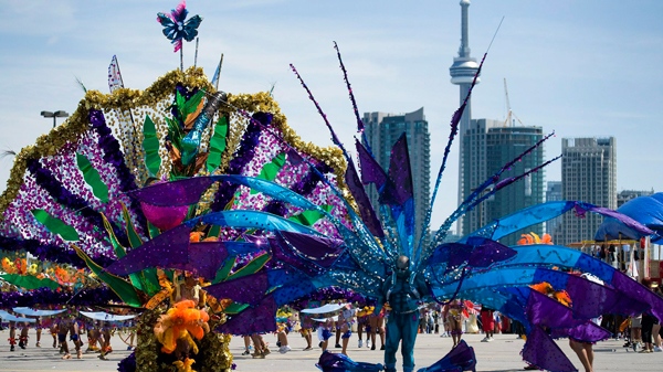 Revelers take part in the 2010 Caribana Parade in Toronto on Saturday, July 31, 2010. (Adrien Veczan / THE CANADIAN PRESS)