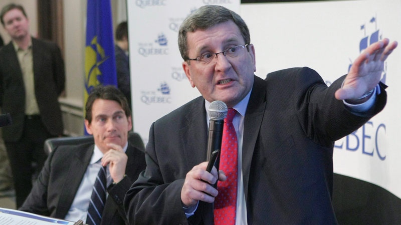 Quebec city mayor Regis Labeaume gestures during a press conference as Pierre-Karl Peladeau, CEO of Quebecor, looks on at city hall in Quebec City, Tuesday, March 1, 2011. (Francis Vachon / THE CANADIAN PRESS) 