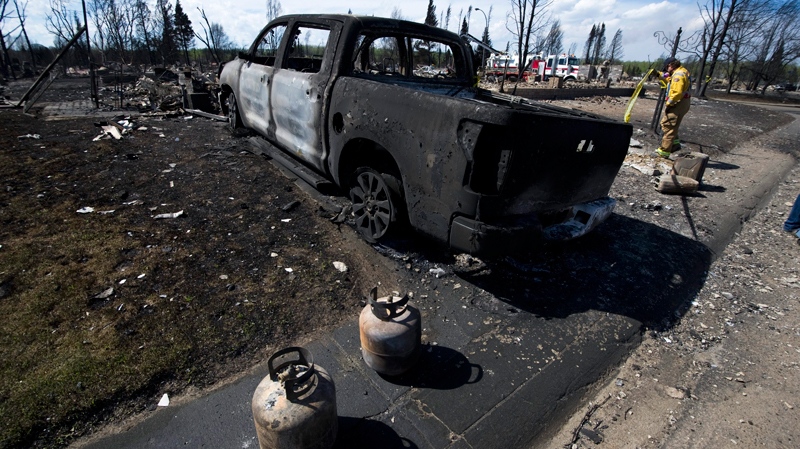 Crews work to shut off gas and water in a burned-out neighbourhood in Slave Lake, Alta., on Wednesday, May 18, 2011. (Ian Jackson / THE CANADIAN PRESS)