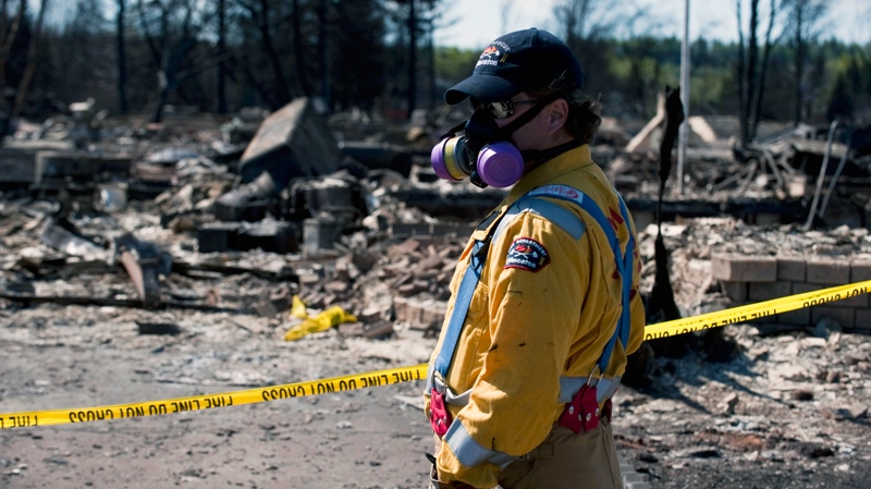 Crews work to shut off gas and water in a burned-out neighbourhood in Slave Lake, Alta., on Wednesday, May 18, 2011. (Ian Jackson / THE CANADIAN PRESS)