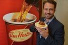 Jason Priestley and The Tortoise Torte, winner of Tim Hortons Duelling Donuts contest, created by Andrew Shepherd of Scarborough, Ont. are seen in this image provided by Tim Hortons.