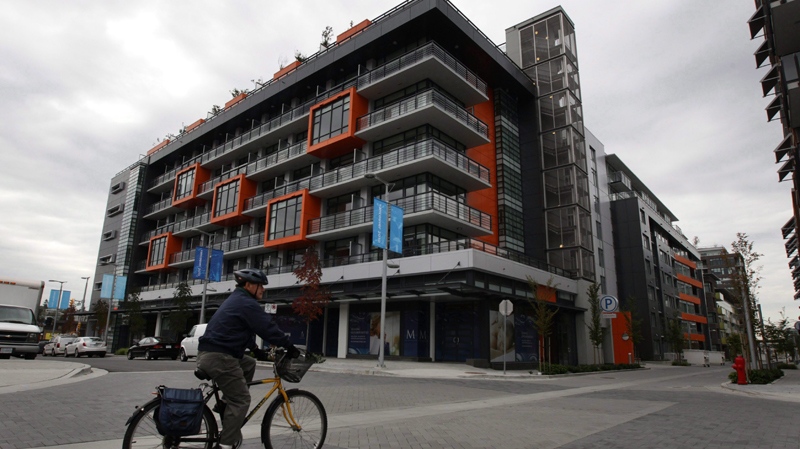 A cyclist rides through the Millennium Water development which was the athletes' village during the 2010 Winter Olympics in Vancouver, B.C., on Thursday October 7, 2010. (Darryl Dyck / THE CANADIAN PRESS)