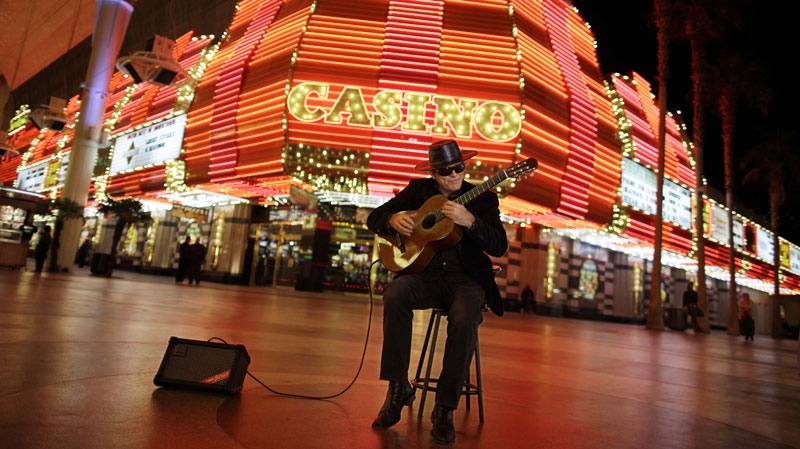 In this photo taken on Thursday, Jan. 13, 2011, classical guitarist Esteban, plays along Fremont Street at the Fremont Street Experience, in downtown Las Vegas. (AP Photo/Julie Jacobson)
