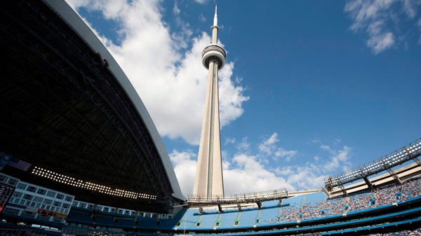 The CN Tower looms over the Toronto Blue Jays and Detroit Tigers as the Rogers Centre's roof is open for the first time in the 2011 MLB baseball season in Toronto Saturday, May 7, 2011. THE CANADIAN PRESS/Darren Calabrese