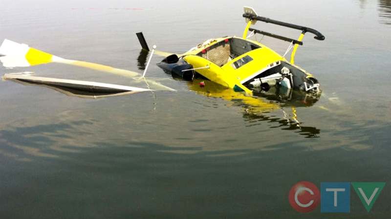 A Bell 212 helicopter is shown after crashing near Canyon Creek on the shore of Lesser Slave Lake, just northwest of Slave Lake on Friday, May 20, 2011. (Courtesy: CTV viewer Lorne Lukan)