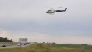 The RCMP 'K' Division helicopter hovers above the QE II highway (photo courtesy: Airdrie Integrated Traffic Unit) 