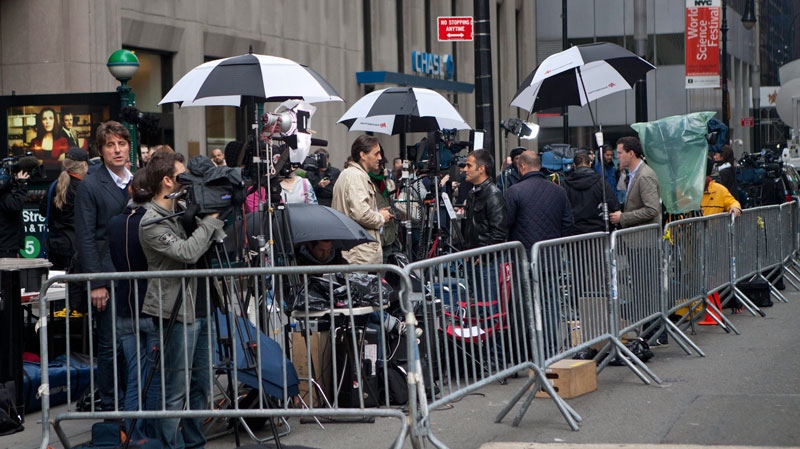Members of the media record video outside the entrance to 71 Broadway in New York where former IMF chief Dominique Strauss-Kahn is under house arrest after he was released from Rikers Island jail on $1 million bail plus $5 million bond, on Sunday, May 22, 2011. (AP / Andrew Burton)