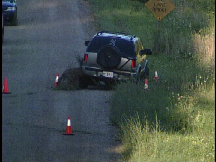 Police investigate at the scene of a collision between an SUV and bicycle near Aylmer, Ont. on Saturday, August 24, 2013.