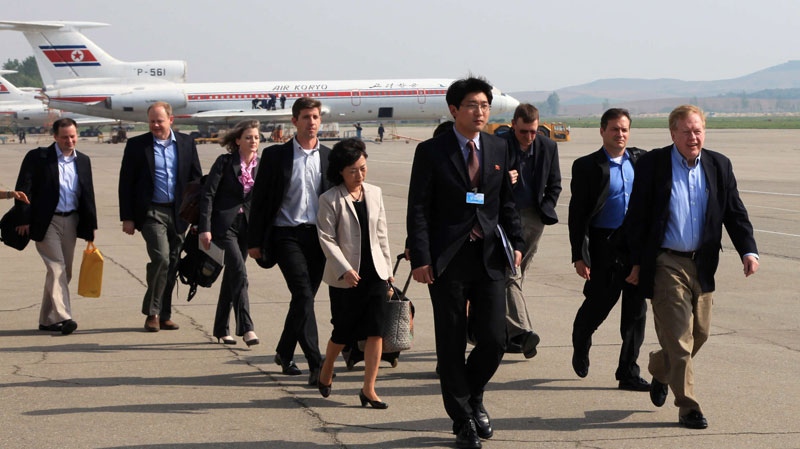 In this photo released by China's Xinhua news agency, a U.S. delegation led by Robert King, far right, U.S. special envoy for North Korean human rights issues, and Jon Brause, second right, U.S. Agency for International Development (USAID) deputy assistant administrator for the office of foreign disaster assistance, arrive at Pyongyang airport on Tuesday May 24, 2011. (AP / Xinhua, Zhang Li) 