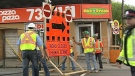 Workers close Bank Street at Holmwood Avenue Tuesday, May 24, 2011.