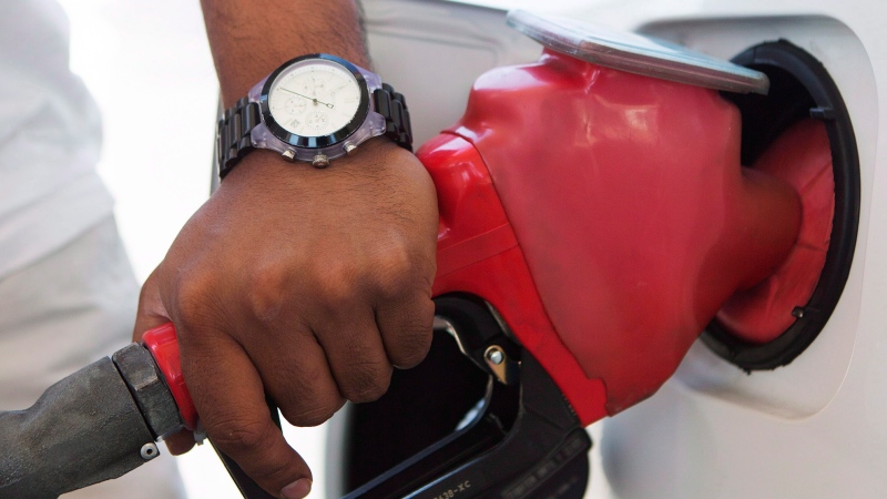 A man pumps fuel in Toronto. (The Canadian Press/Michelle Siu)