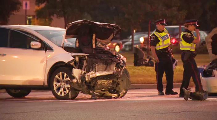 Police officers survey the scene of a three-vehicle crash at Bishop Street and Franklin Boulevard in Cambridge on Wednesday, Aug. 28, 2013.