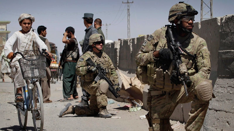 U.S. soldiers take position near the scene of an explosion in Kandahar south of Kabul, Afghanistan on Sunday, May 22, 2011. (AP / Allauddin Khan)