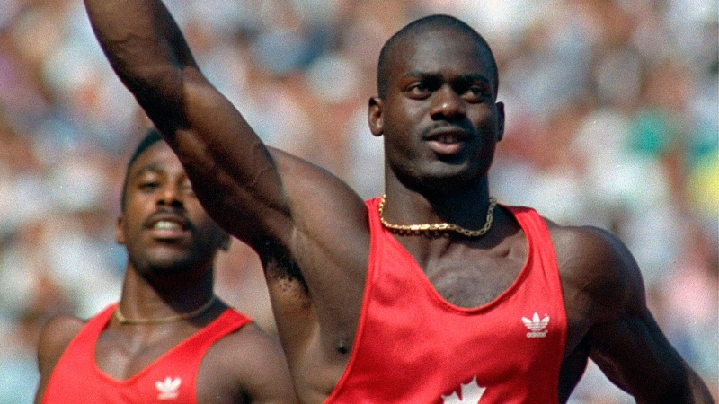 Canadian sprinter Ben Johnson celebrates Olympic gold in the 100 meters, a medal that would later be taken away because of a positive steroids test. (AP / Dieter Endlicher)