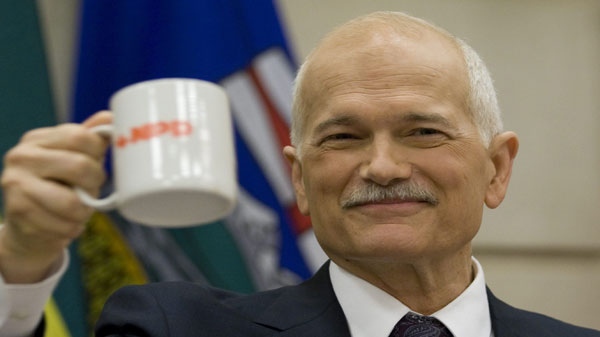 NDP leader Jack Layton raises his coffee mug to members of caucus at the start of the second day of caucus meetings on Parliament Hill in Ottawa, Wednesday May 25, 2011. THE CANADIAN PRESS/Adrian Wyld