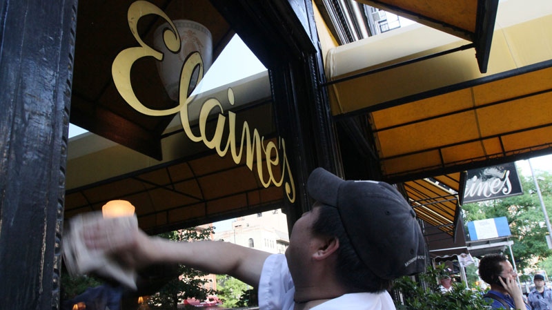 Bernardo Mendez cleans the windows outside Elaine's in New York Wednesday May 25, 2011. The restaurant is scheduled to close on Thursday May 26, 2011. Elaine Kaufman died in December after running Elaine's for 48 years. Longtime manager Diane Becker inherited the restaurant and tried to keep it open but says the place can't survive without Kaufman.