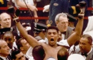 Muhammad Ali, or Cassius Clay at the time, strikes a familiar pose as he shouts "I am the greatest," as he leaves the ring, arms raised, following his defeat of former heavyweight boxing champion Sonny Liston in Miami Beach, Fla., February 25, 1964. (AP)