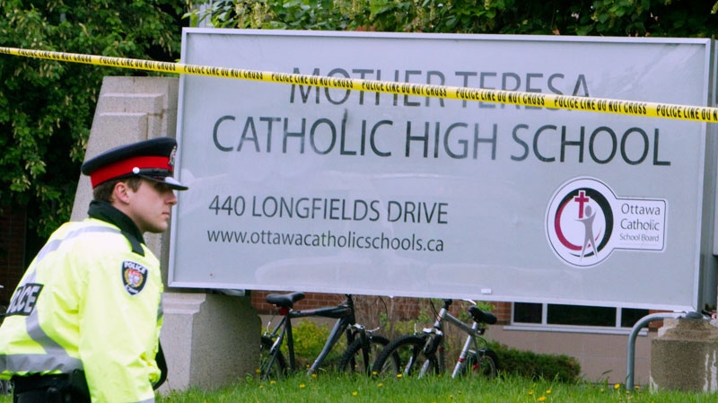 A policeman stands guard at the scene outside Mother Teresa Catholic School in Ottawa, Thursday, May 26 2011. (Fred Chartrand / THE CANADIAN PRESS)