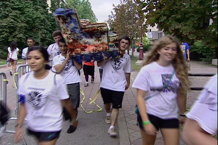 First year engineering students at the University of Ottawa carry a couch for frosh week