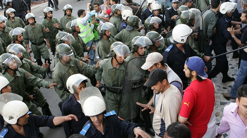 Moroccan police officers chase demonstrators as they break up a rally organized by the 20th February, the Moroccan Arab Spring movement in Casablanca, Morocco, Sunday May 29, 2011. (AP / Abdeljalil Bounhar)