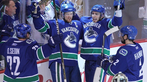 Vancouver Canucks' Alex Burrows, second right, celebrates his goal with teammates Daniel Sedin, of Sweden, (22) Henrik Sedin, of Sweden, second right, and Dan Hamhuis (2) as San Jose Sharks goaltender Antti Niemi, of Finland look on during the first period of game 5 of NHL Western Conference final Stanley Cup playoff hockey action in Vancouver, B.C., Tuesday, May 24, 2011. (Jonathan Hayward / THE CANADIAN PRESS)