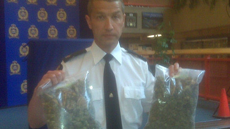 Edmonton police Inspector Greg Preston holds two 1.5 pound bags of marijuana recently seized by police.