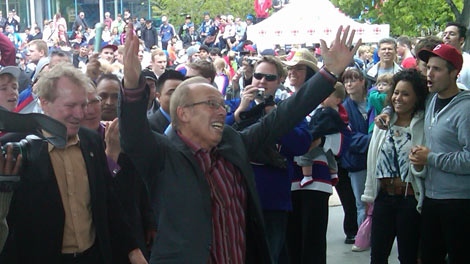 Winnipeg Mayor Sam Katz leads a conga line at The Forks following the announcement of the NHL returning to Winnipeg. 