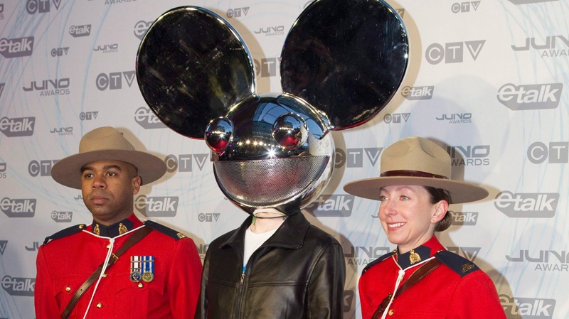 Deadmau5 poses with two Mounties as he arrives at the Juno Awards in Toronto on Sunda,y March 27, 2011. (Chris Young / THE CANADIAN PRESS)  