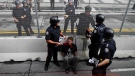 A demonstrator is arrested by Canadian police officers near the fence that surrounds the G20 Summit venue in Toronto, Canada, Saturday June 26, 2010. (AP Photo/Lefteris Pitarakis)