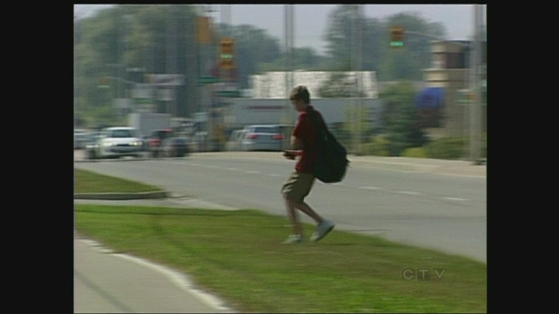 A student crosses Fanshawe Park Road near St. Andre Bessette Catholic High School in London, Ont. on Tuesday, Sept. 10, 2013.