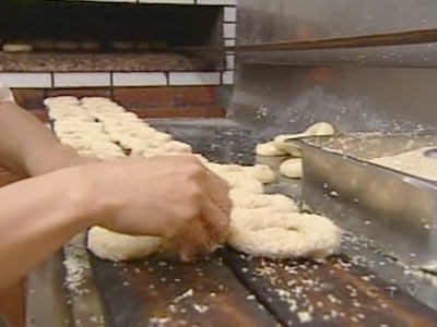 An employee of Montreal's Fairmount Bagel prepares the famous baked goods on Sunday, June 1, 2008.
