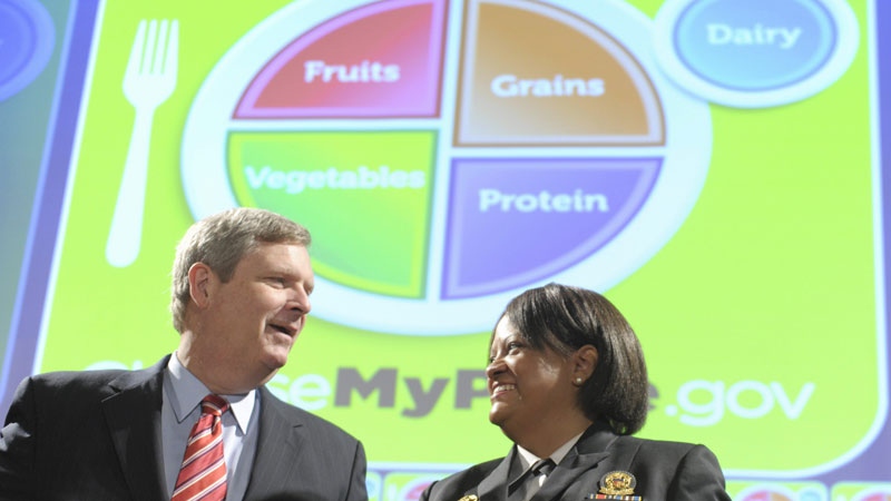 Agriculture Secretary Tom Vilsack, left, talks with Surgeon General Regina Benjamin, at the Agriculture Department in Washington, Thursday, June 2, 2011, during an event to unveil the department's new food icon at. The new food icon replaced the food pyramid icon. (AP Photo/Susan Walsh)