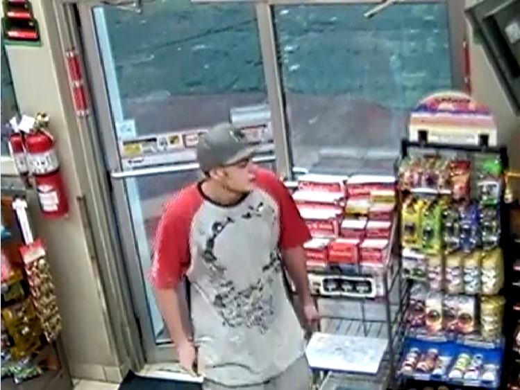 Surveillance footage shows a suspect in the robbery of a Cambridge gas station.